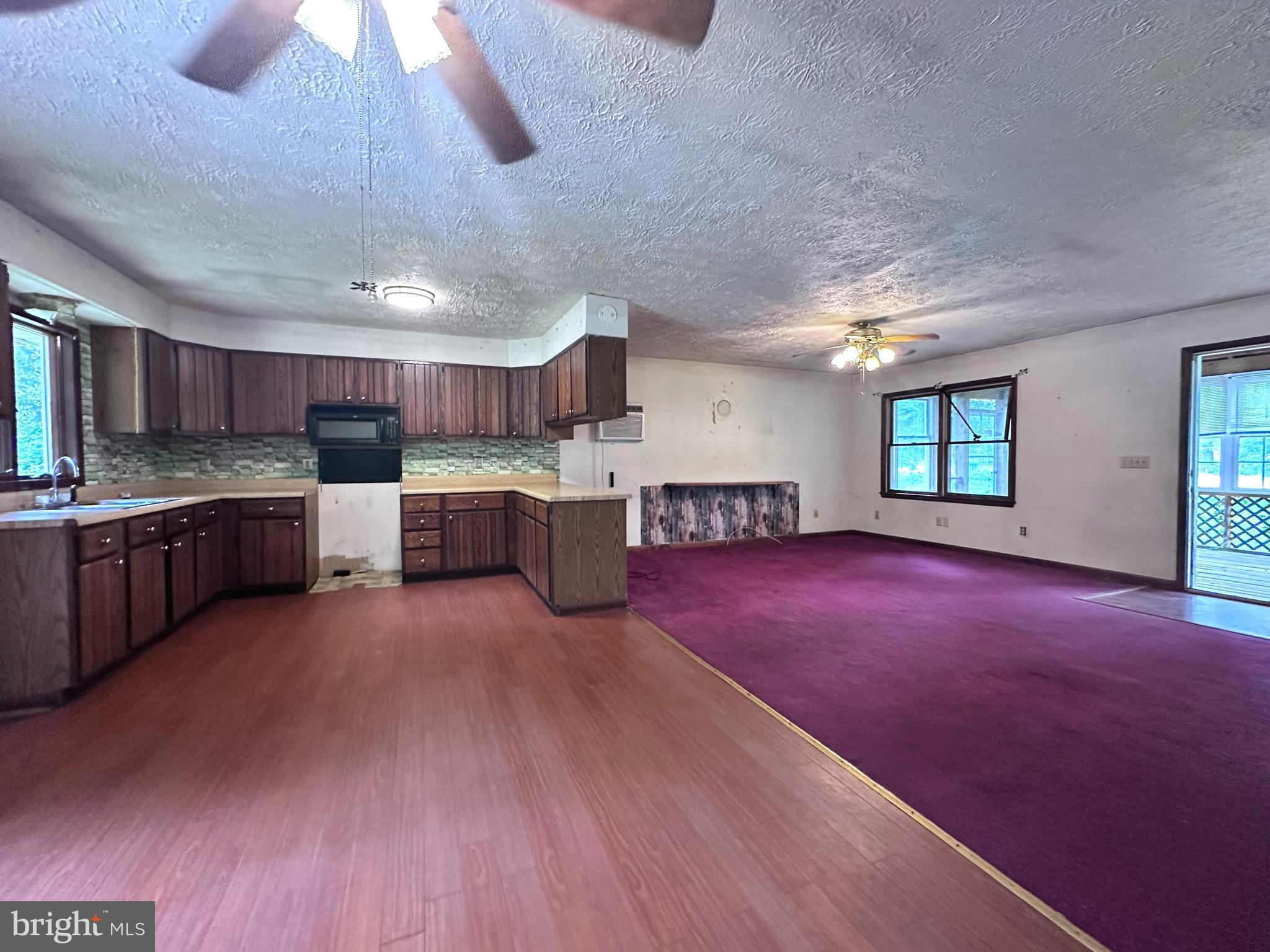 8027 Willow Grove Road Camden Wyoming, DE 19934 - Photo 11 of 16 a open kitchen with stainless steel appliances granite countertop a stove and a refrigerator