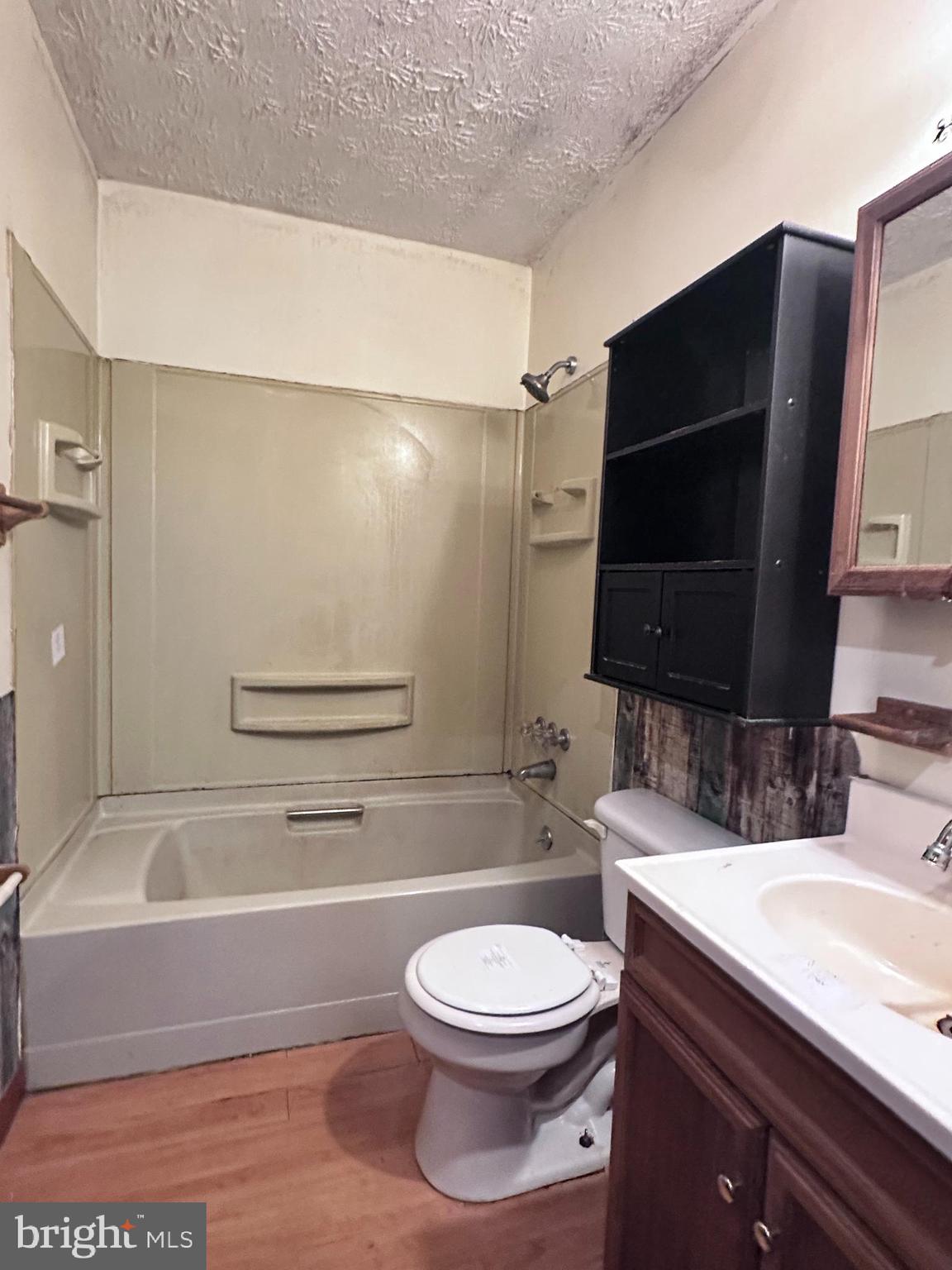 8027 Willow Grove Road Camden Wyoming, DE 19934 - Photo 15 of 16 a bathroom with a granite countertop bathtub sink vanity mirror and toilet