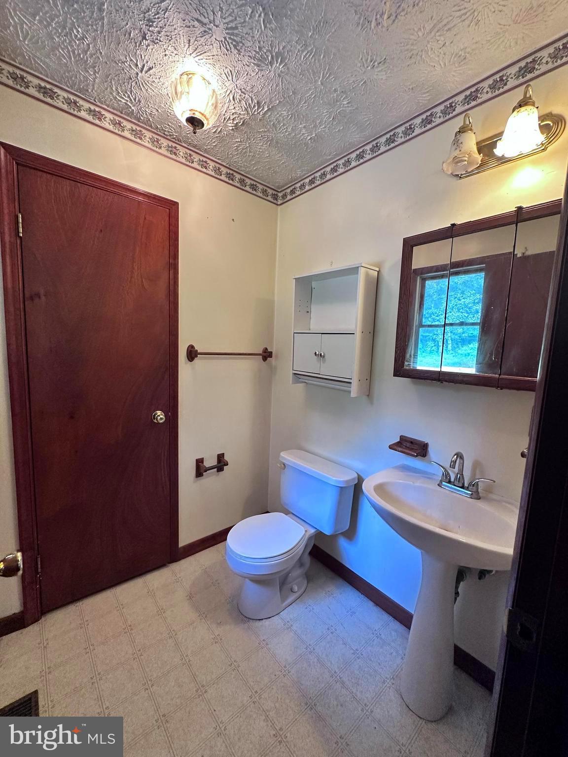 8027 Willow Grove Road Camden Wyoming, DE 19934 - Photo 16 of 16 a bathroom with a sink mirror vanity and toilet
