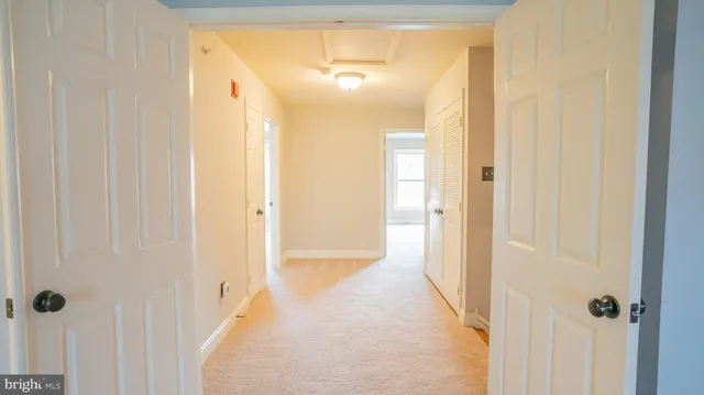 a view of a bathroom from a hallway