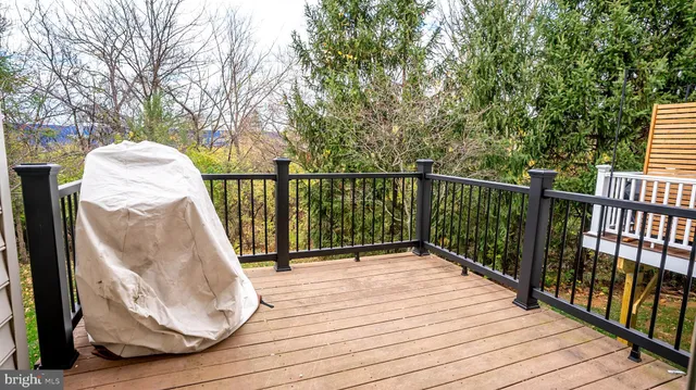 a view of a balcony with wooden floor and fence