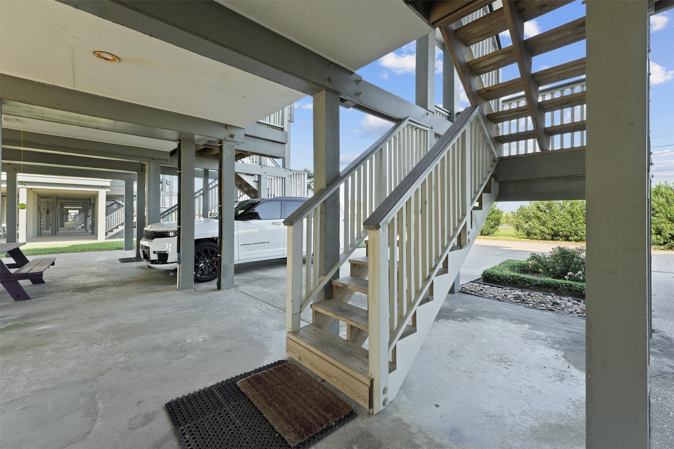 17607 Termini-San Luis Pass Road Galveston, TX 77554 - Photo 33 of 42 A convenient staircase is the focal point of this covered patio, which also provides ample parking for vehicles. This versatile area can be used for parking, outdoor activities, or relaxing in the coastal breeze.