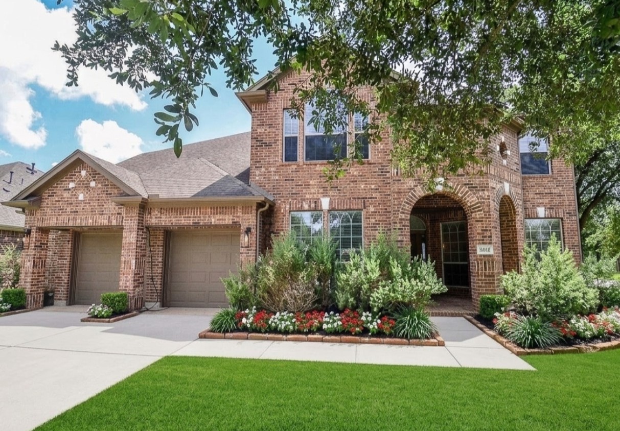 19802 Shavon Springs Drive Spring, TX 77388 - Photo 2 of 30 Charming brick home with a welcoming front entrance, lush landscaping, and a spacious two-car garage.