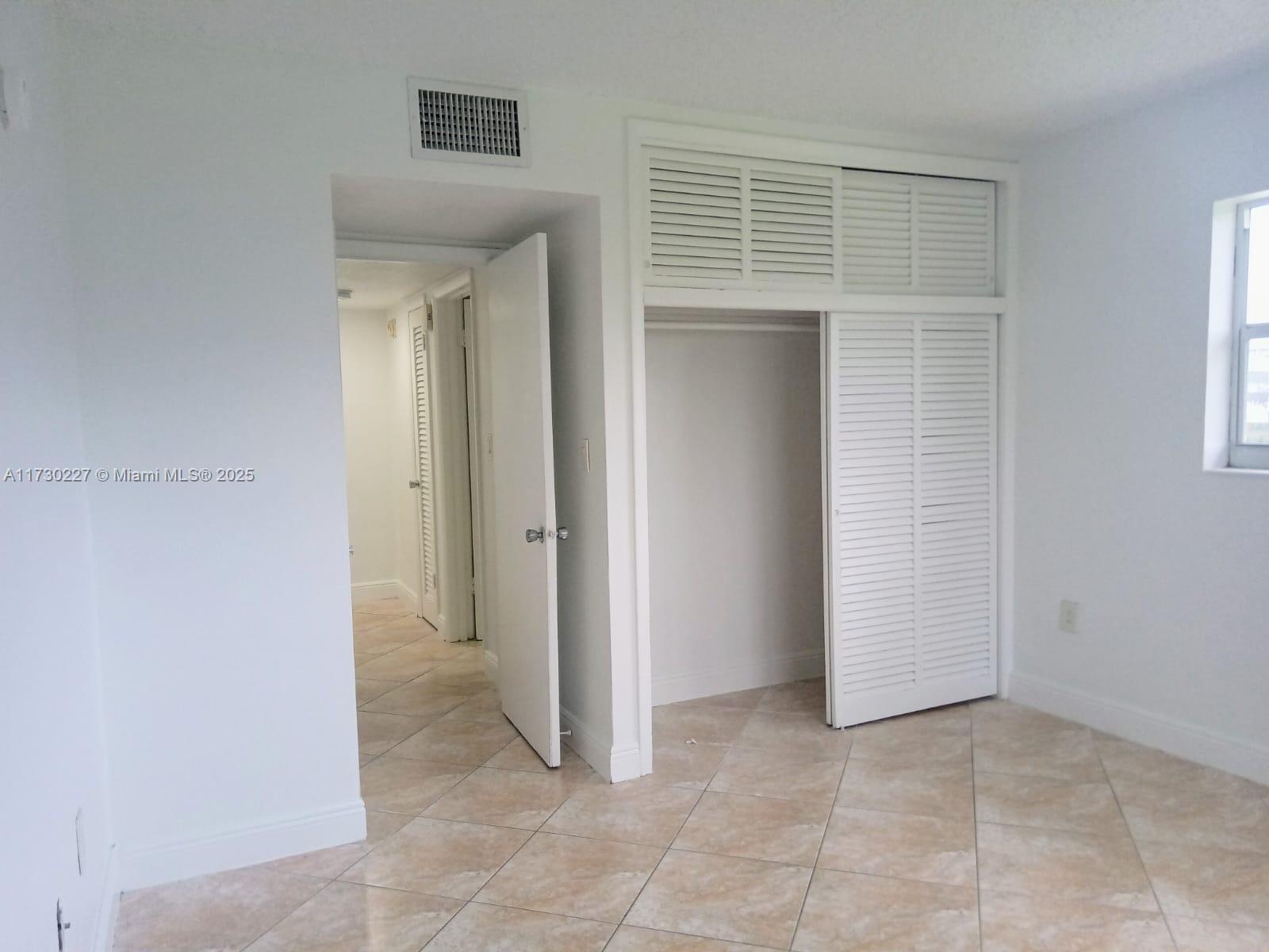 7348 Southwest 82nd Street, Unit C217 Miami, FL 33143 - Photo 12 of 19 a view of a hallway to rooms and stairs
