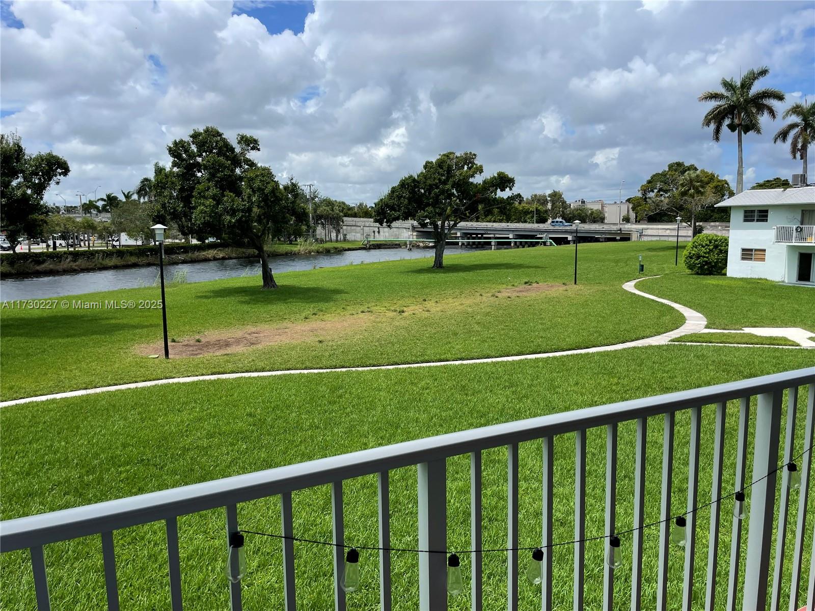 7348 Southwest 82nd Street, Unit C217 Miami, FL 33143 - Photo 16 of 19 a view of a playground and a lake