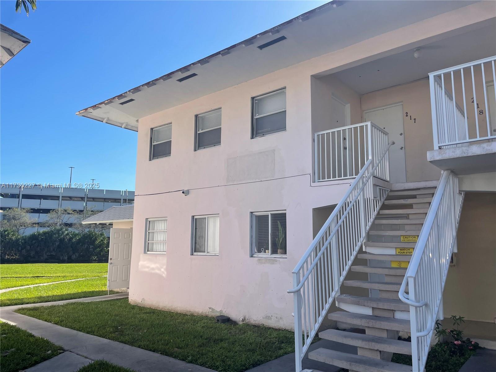 7348 Southwest 82nd Street, Unit C217 Miami, FL 33143 - Photo 17 of 19 a front view of a house with a yard