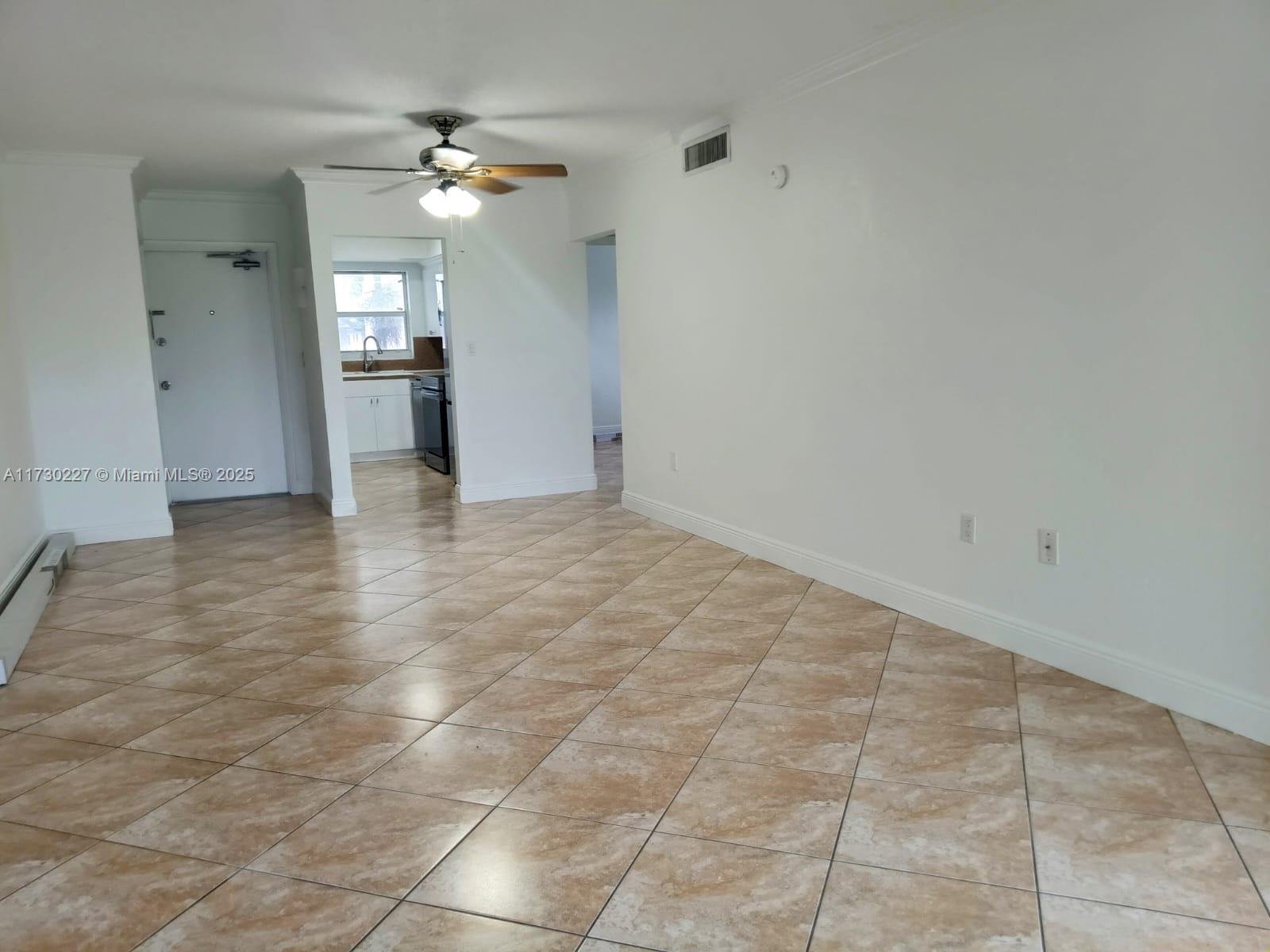 7348 Southwest 82nd Street, Unit C217 Miami, FL 33143 - Photo 8 of 19 a view of an empty room and a chandelier fan