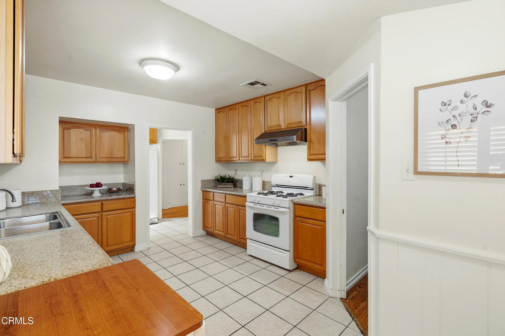 1809 South Palm Avenue Alhambra, CA 91803 - Photo 17 of 44 a kitchen with stainless steel appliances granite countertop a stove a sink and a refrigerator