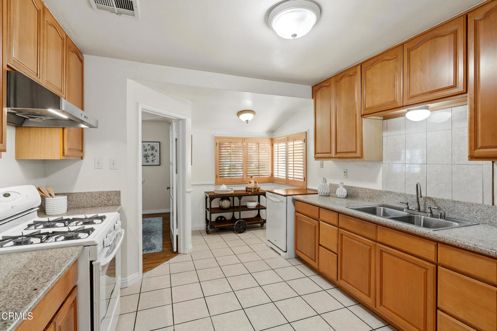 1809 South Palm Avenue Alhambra, CA 91803 - Photo 19 of 44 a kitchen with stainless steel appliances a sink stove and cabinets