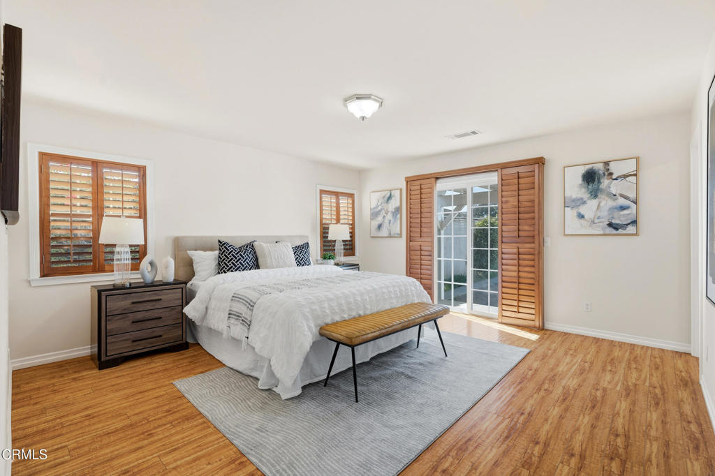 1809 South Palm Avenue Alhambra, CA 91803 - Photo 22 of 44 a bedroom with a large bed and a wooden floor