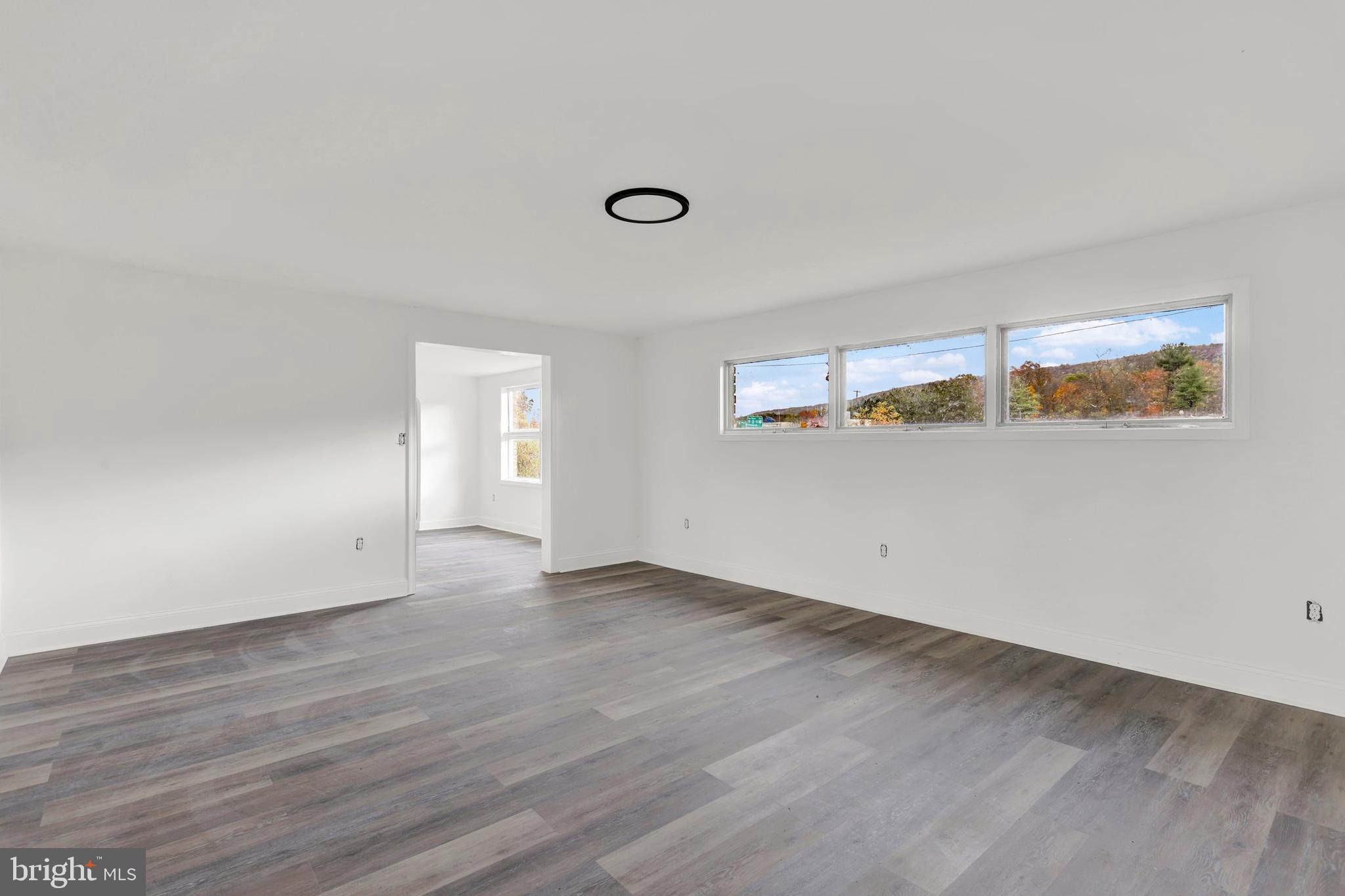 664 South Breezewood Road Breezewood, PA 15533 - Photo 12 of 24 a view of an empty room with wooden floor and a window