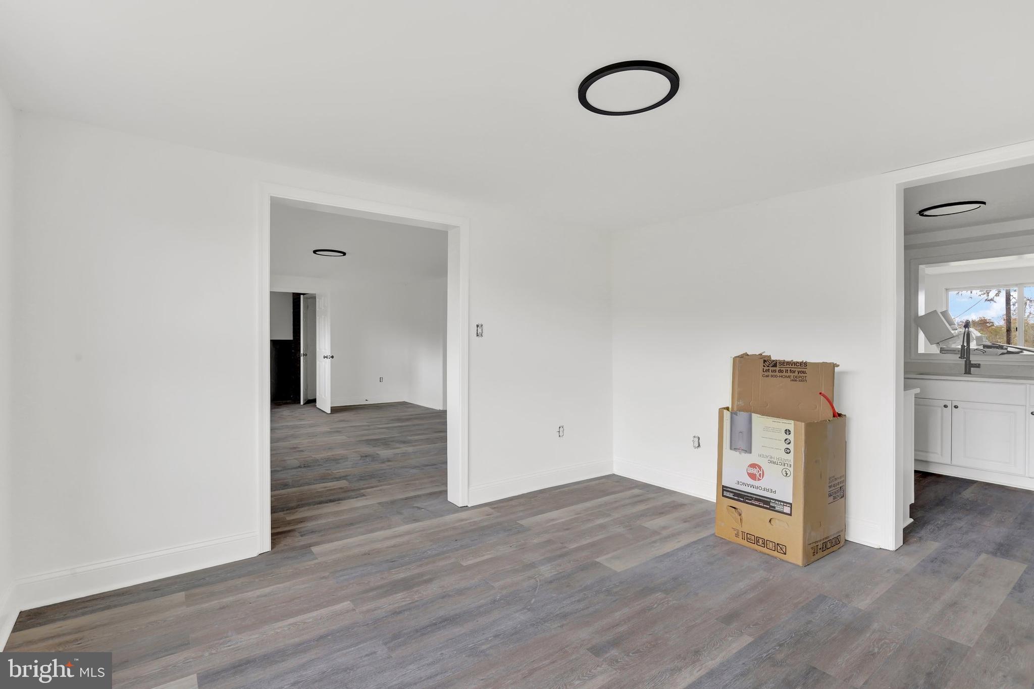 664 South Breezewood Road Breezewood, PA 15533 - Photo 9 of 24 an empty room with wooden floor and mirror