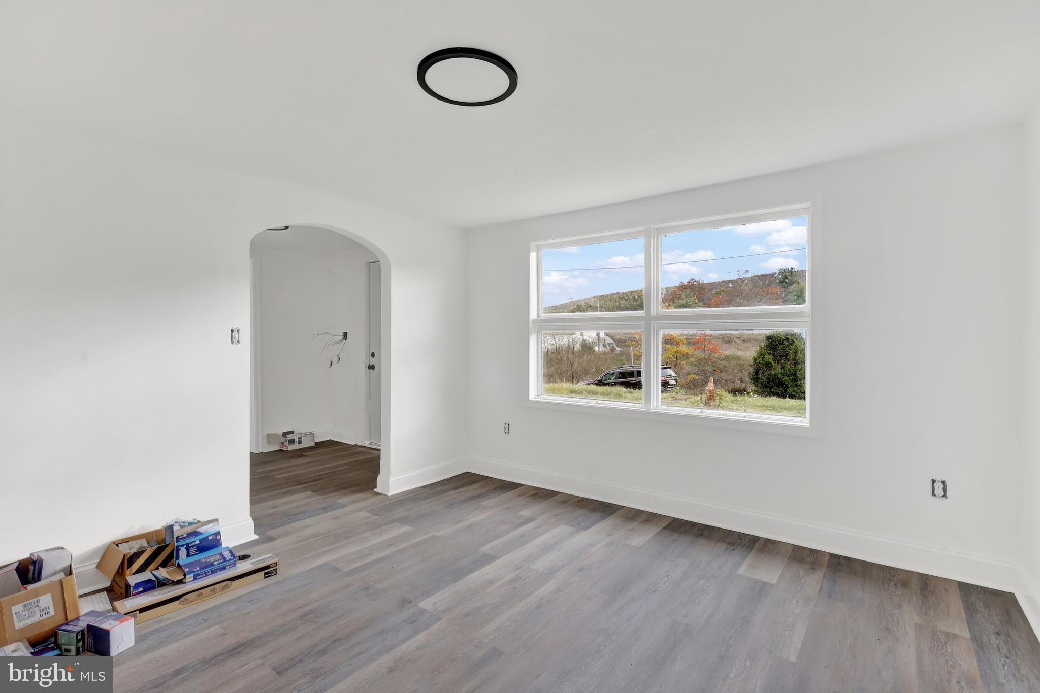 664 South Breezewood Road Breezewood, PA 15533 - Photo 10 of 24 an empty room with wooden floor and windows