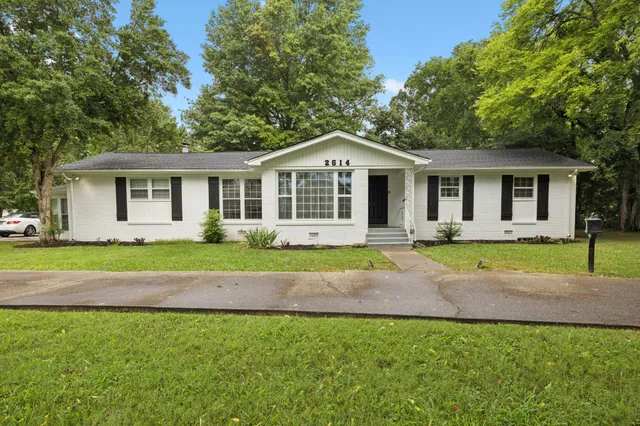 a view of a house with backyard and garden