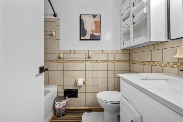 a kitchen with a refrigerator and a stove top oven