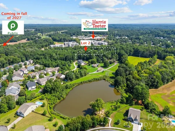 an aerial view of a houses with a lake view