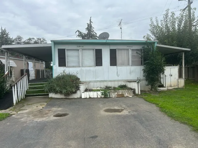 a view of a house with a yard and a garage