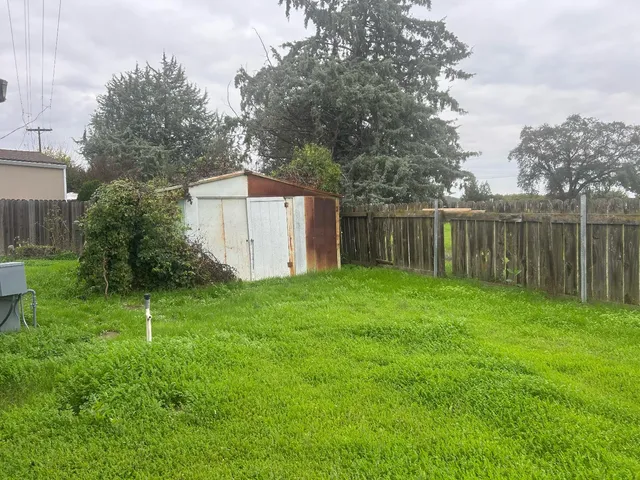 a backyard of a house with lots of green space