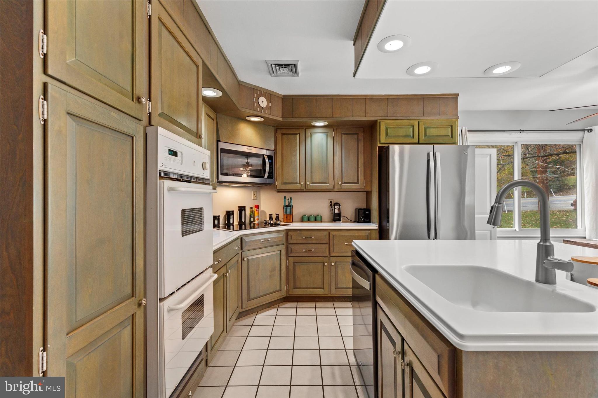 1605 Colonial Road Harrisburg, PA 17112 - Photo 15 of 39 a kitchen with a sink a refrigerator and cabinets