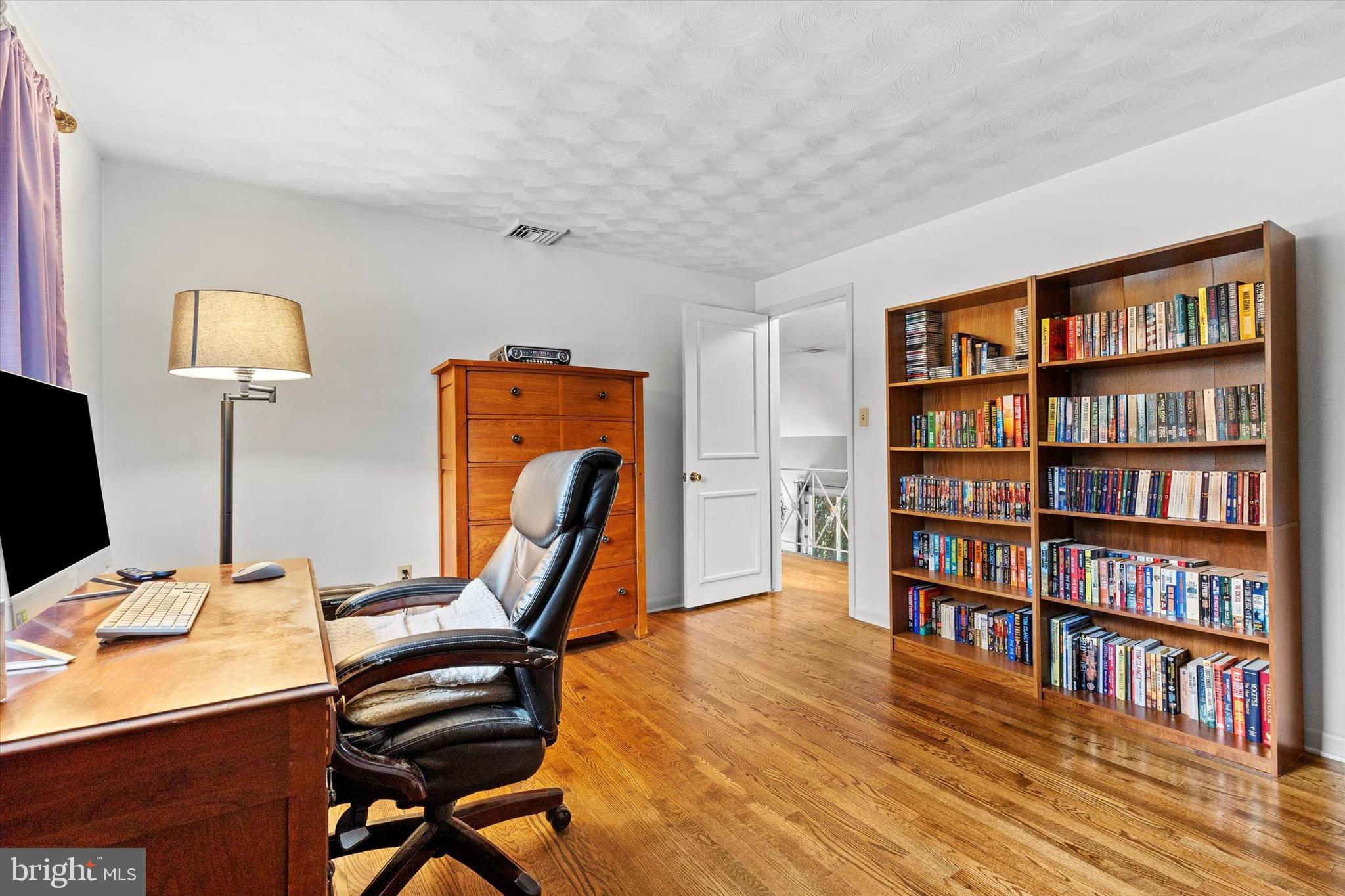 1605 Colonial Road Harrisburg, PA 17112 - Photo 22 of 39 a view of a workspace with furniture and a bookshelf