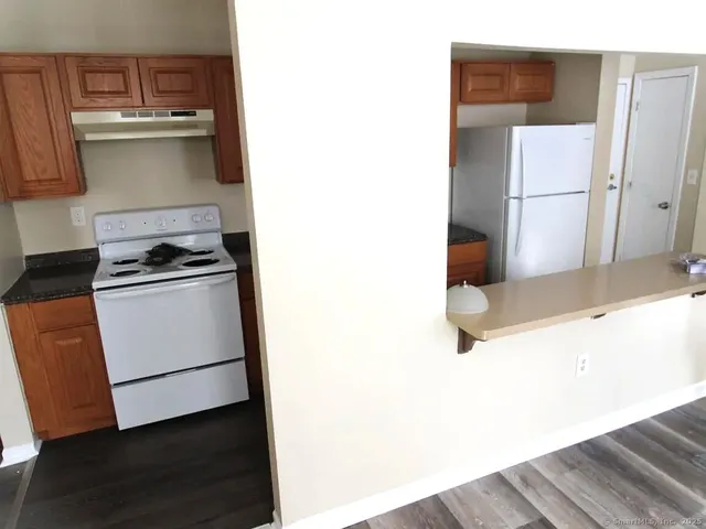 a kitchen with a sink and a refrigerator