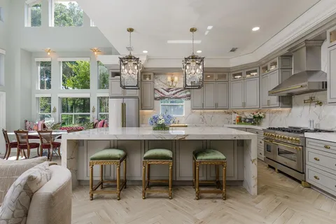 a kitchen with cabinets and chairs