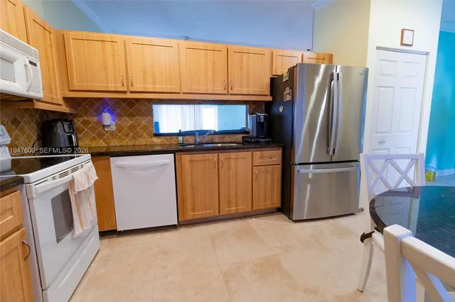 a kitchen with stainless steel appliances granite countertop a refrigerator sink and cabinets