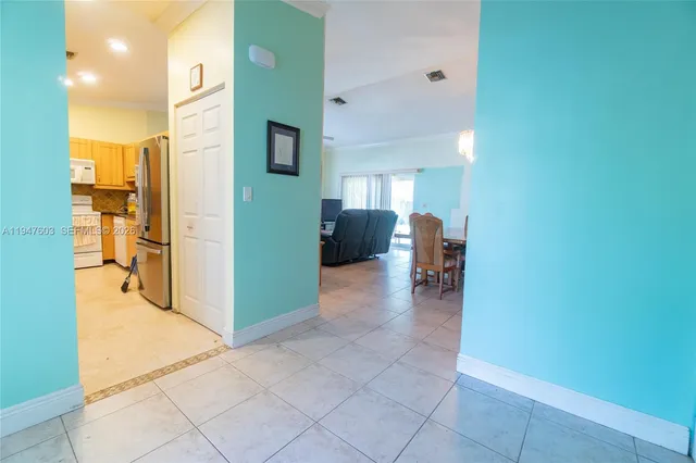 a view of a hallway with wooden floor and furniture