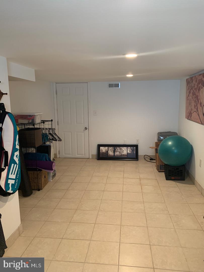 1833 East Albert Street Philadelphia, PA 19125 - Photo 13 of 13 a living room with furniture a flat screen tv and gym equipment
