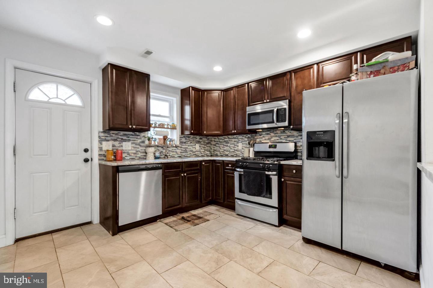 1833 East Albert Street Philadelphia, PA 19125 - Photo 4 of 13 a kitchen with stainless steel appliances granite countertop a refrigerator and a stove top oven