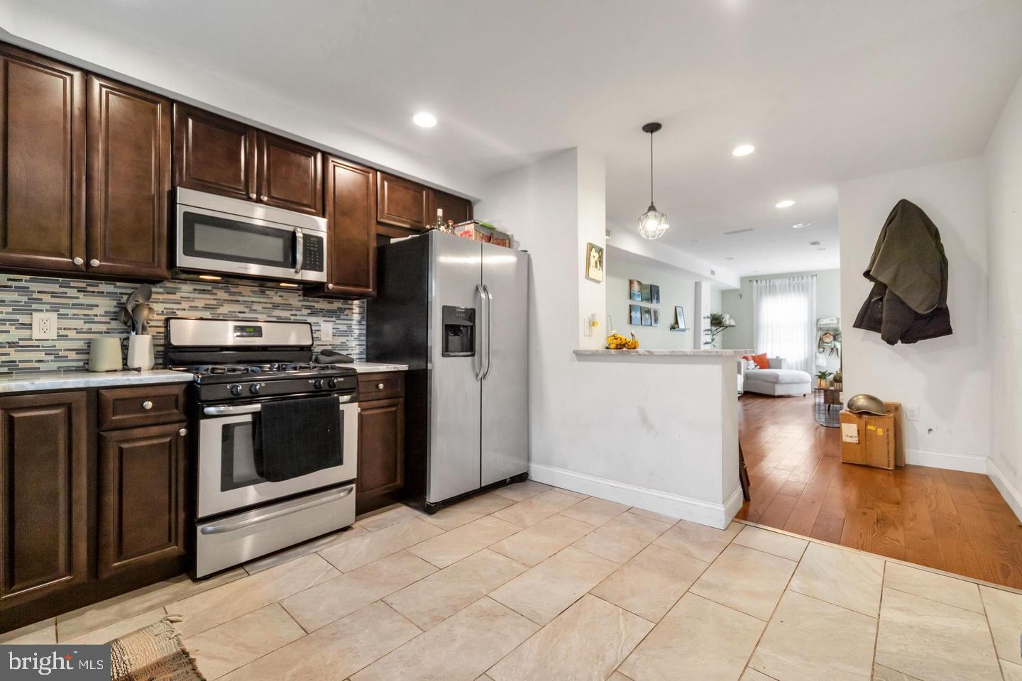 1833 East Albert Street Philadelphia, PA 19125 - Photo 5 of 13 a kitchen with stainless steel appliances granite countertop a refrigerator a stove top oven a sink and dishwasher