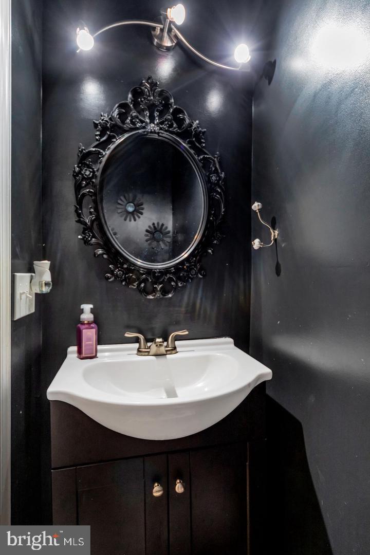 1833 East Albert Street Philadelphia, PA 19125 - Photo 6 of 13 a bathroom with a sink a light fixture and a mirror