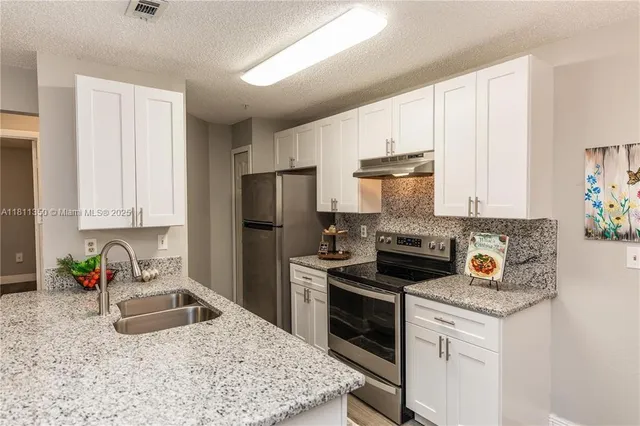 a kitchen with a sink stove and refrigerator