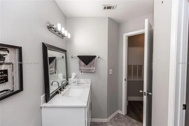 a bathroom with a sink a mirror and a vanity