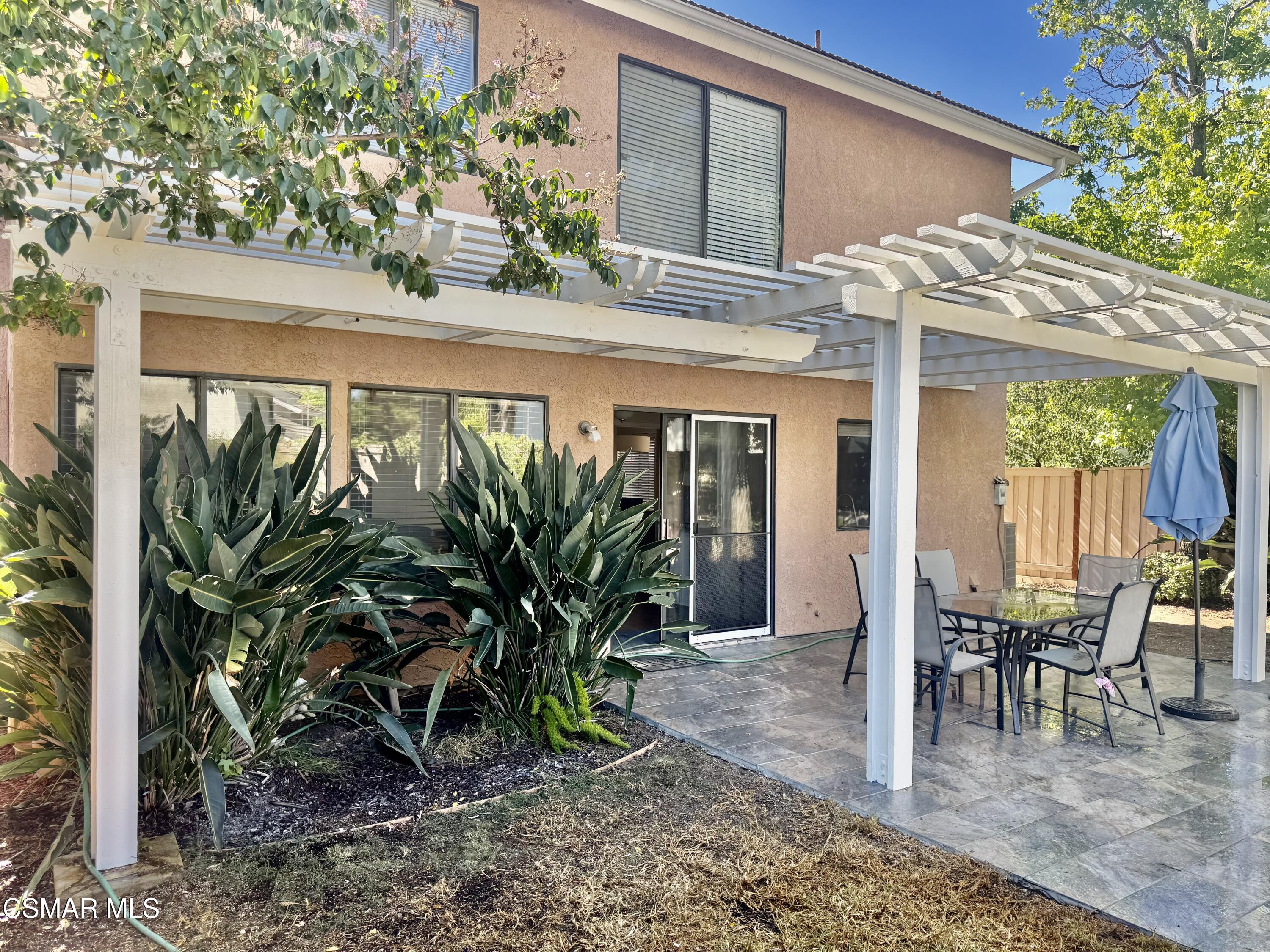 26914 Deerweed Trail Calabasas, CA 91301 - Photo 23 of 37 a view of a patio with table and chairs potted plants and floor to ceiling window and potted plants