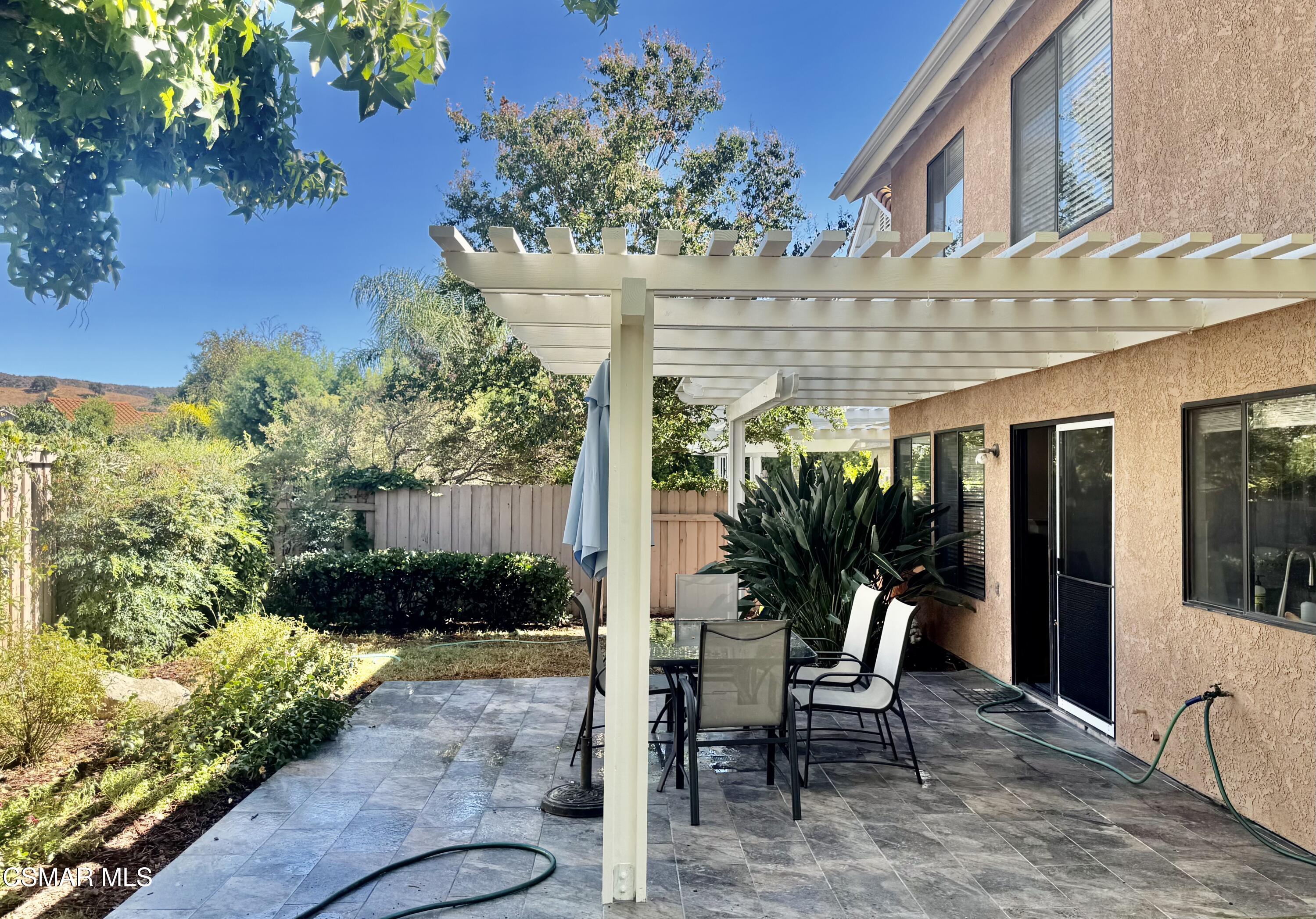 26914 Deerweed Trail Calabasas, CA 91301 - Photo 3 of 37 a view of a patio with table and chairs and potted plants