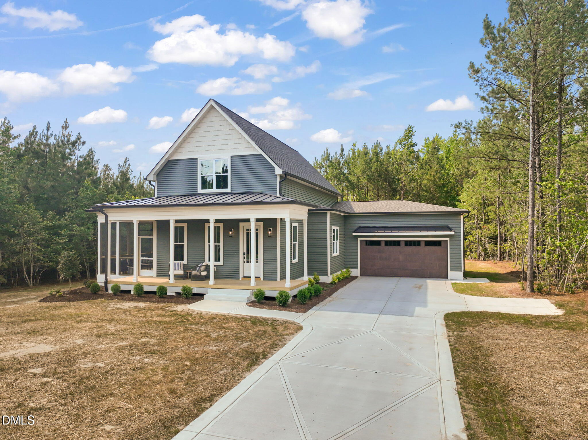a front view of a house with a yard and trees