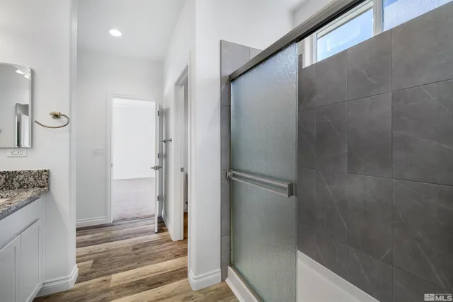 a bathroom with a shower and a sink