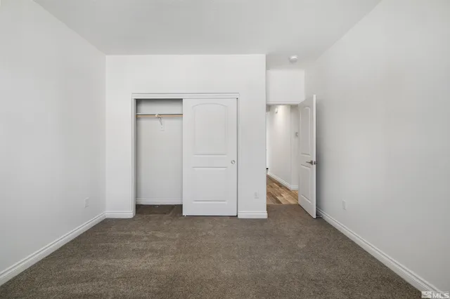 a view of an empty room and closet area