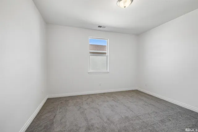 an empty room with a empty space and a window
