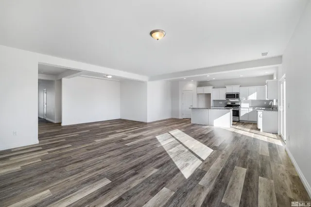 a view of kitchen and hall with wooden floor
