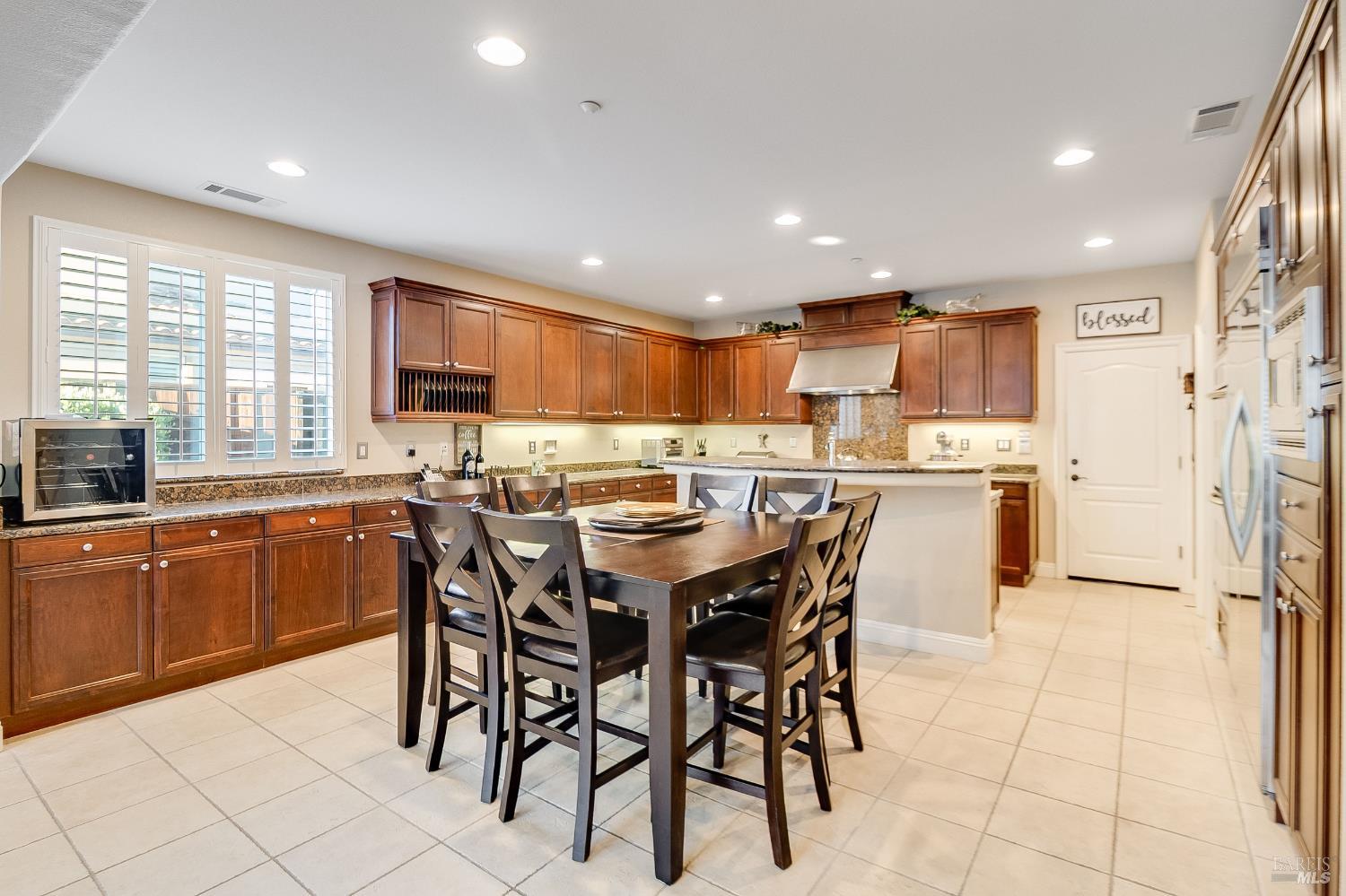 5325 Carole Ridge Court Fairfield, CA 94534 - Photo 27 of 75 a kitchen with stainless steel appliances granite countertop a sink a stove a dining table and chairs