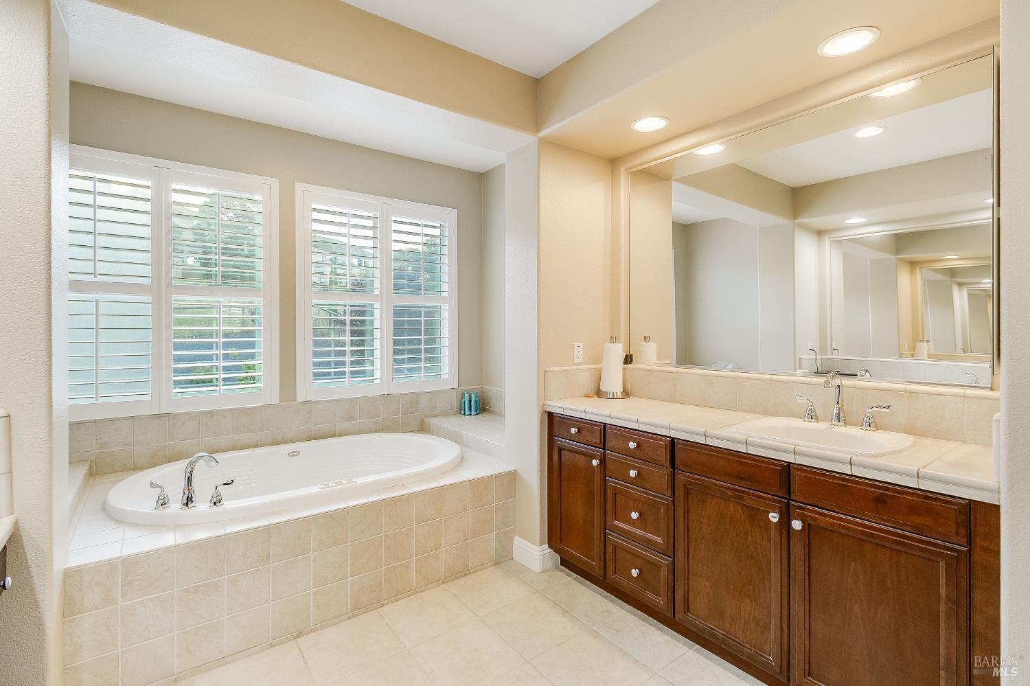 5325 Carole Ridge Court Fairfield, CA 94534 - Photo 45 of 75 a spacious bathroom with a tub sink double vanity granite and mirror
