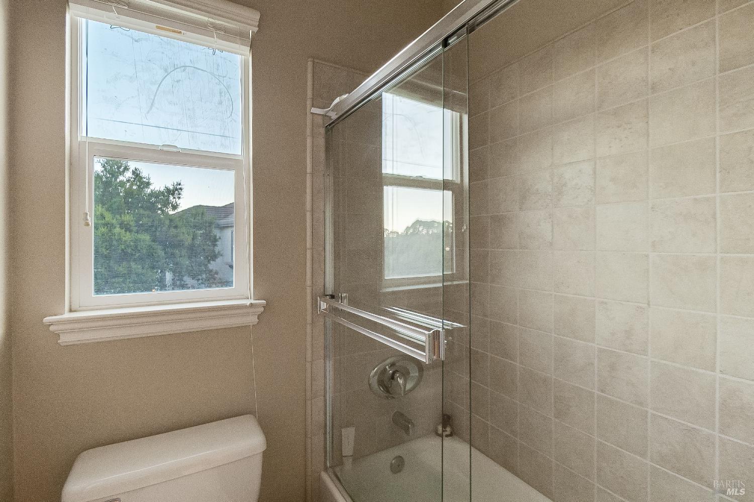 5325 Carole Ridge Court Fairfield, CA 94534 - Photo 56 of 75 a bathroom with a toilet a window and tub