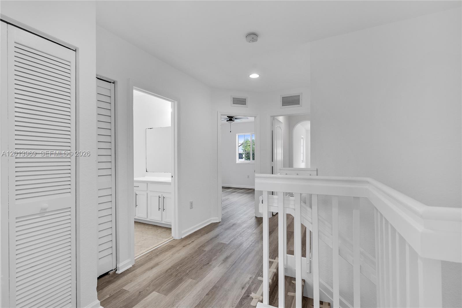 14044 Southwest 273rd Lane, Unit 14044 Homestead, FL 33032 - Photo 16 of 44 a view of a hallway with wooden floor
