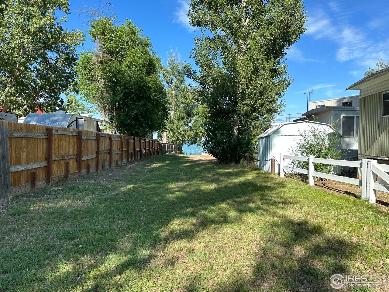 213 Kiowa Road Weldona, CO 80653 - Photo 16 of 25 a view of backyard with table and chairs and wooden fence