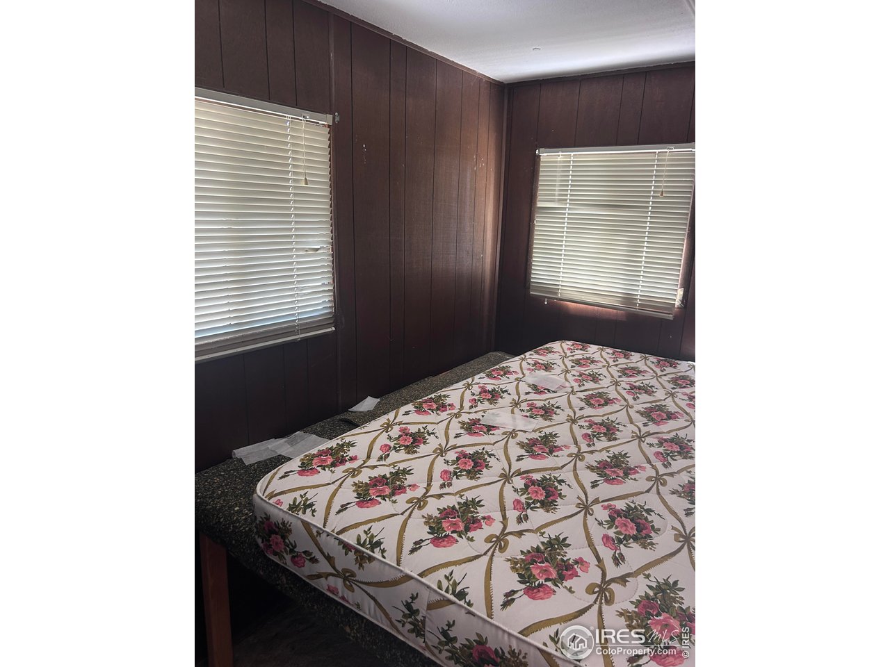 213 Kiowa Road Weldona, CO 80653 - Photo 6 of 25 a bedroom with a bed and a window