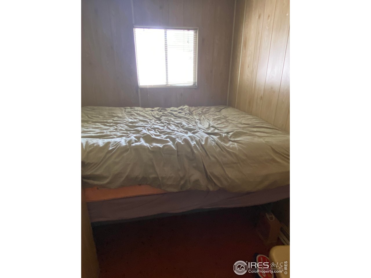 213 Kiowa Road Weldona, CO 80653 - Photo 7 of 25 a bedroom with a bed and a window