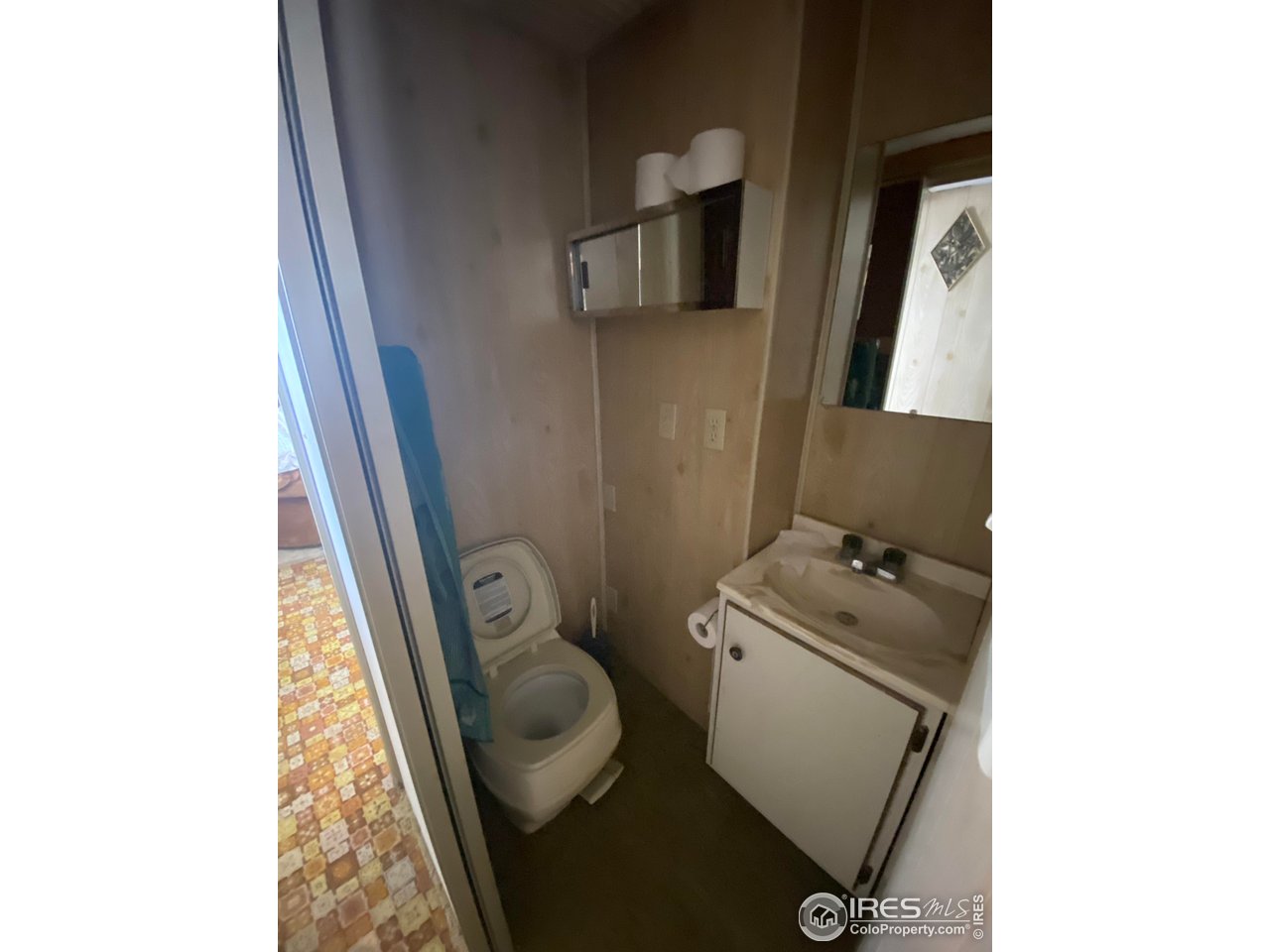 213 Kiowa Road Weldona, CO 80653 - Photo 8 of 25 a bathroom with a toilet sink and mirror