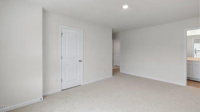 a view of an empty room and a window